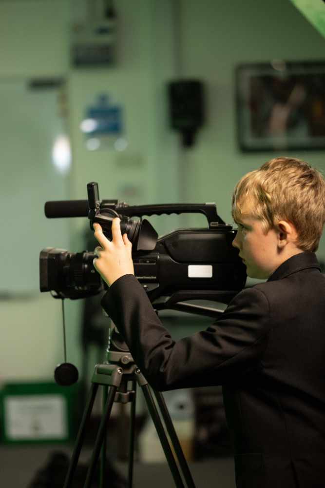 Boy behind a video camera