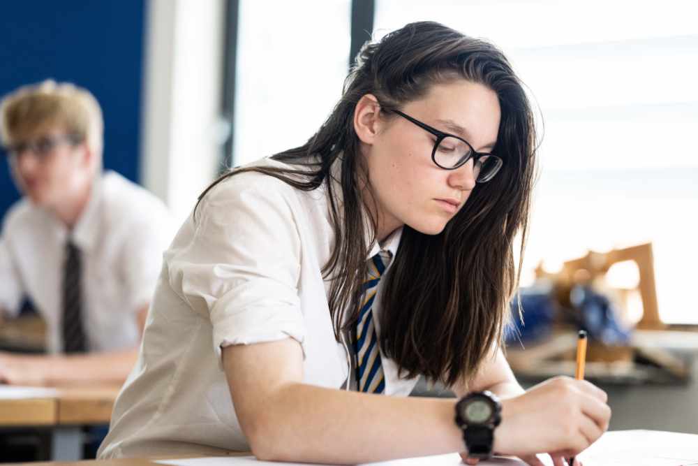 Girl in classroom writing